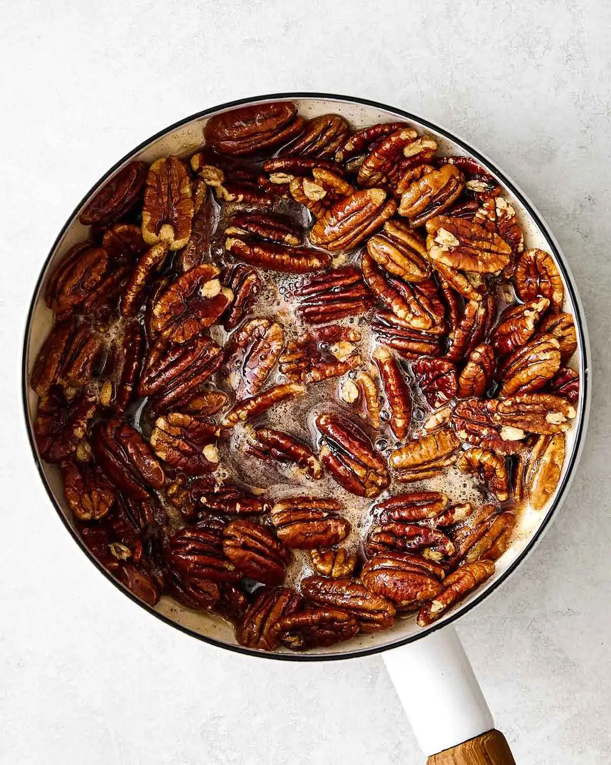 Step one of making candied pecans: boiling them with maple syrup.