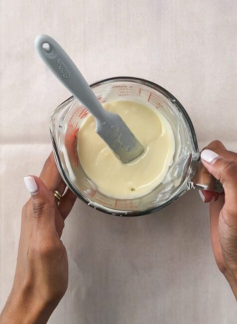 melted white chocolate in a measuring cup