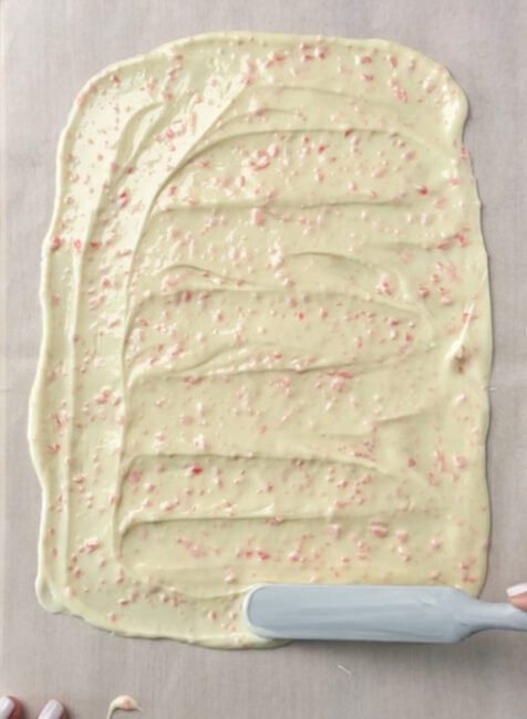 Pop Rocks White Chocolate Bark spread thin on a baking sheet