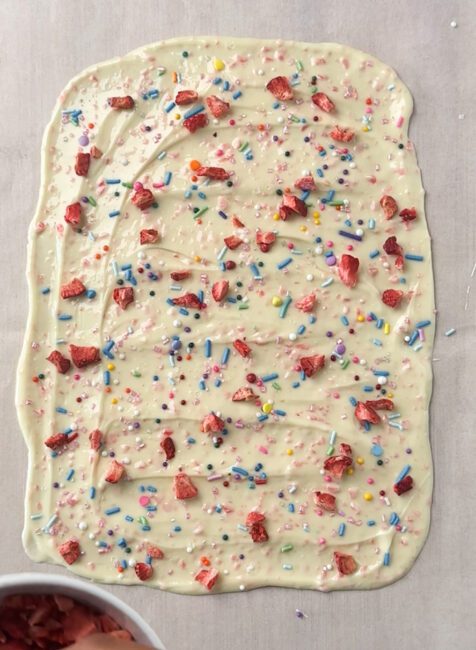 sprinkles and freeze dried strawberries added to Popping Candy Chocolate Bark