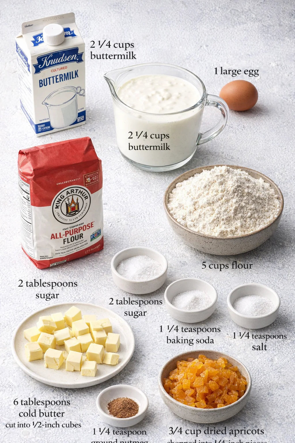 Measured ingredients arranged for Authentic High Altitude Irish Soda Bread - rubinarecipes: 2 1/4 cups buttermilk (I love Knudsen because it’s nice and thick), 1 large egg (at room temperature, around 70°F), 5 cups flour