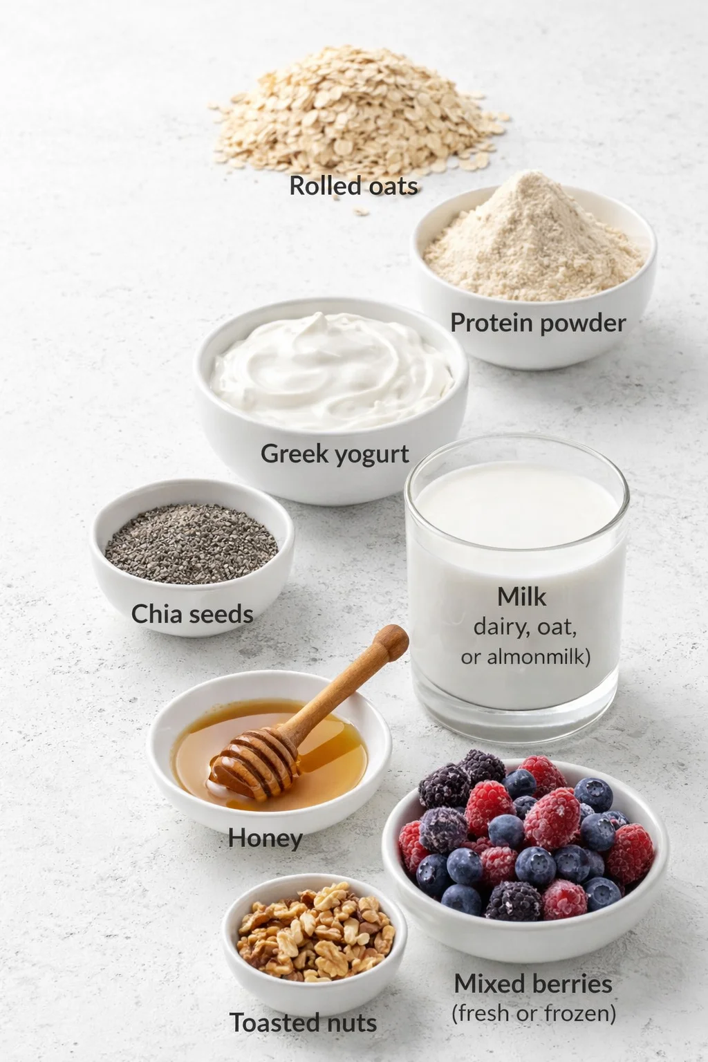 Measured ingredients arranged for High-Protein Overnight Oats: Rolled oats, Protein powder (vanilla or unflavored), Greek yogurt, Chia seeds, Milk (almond, oat, or regular dairy milk), Honey