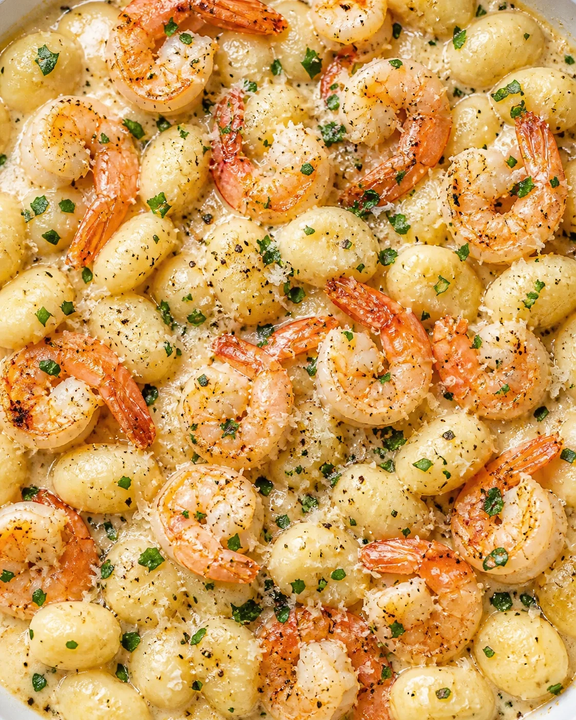 plump shrimp and baby potatoes in a creamy garlic butter sauce, garnished with parsley