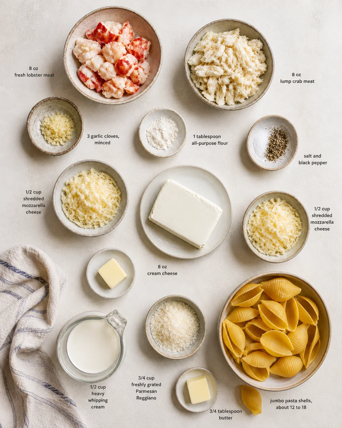 Top-down view of labeled seafood pasta ingredients arranged in ceramic bowls.